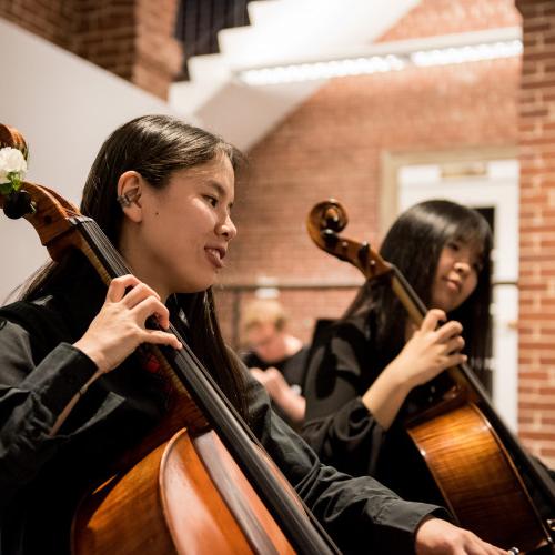Members of a music department's strings group performs a concert in the Wright Museum's Courtyard...