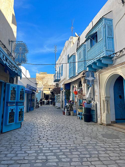 Farah's view of a beautiful blue street in Tunesia.