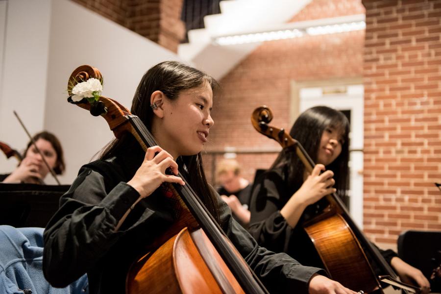 Members of a music department's strings group performs a concert in the Wright Museum's Courtyard Gallery.